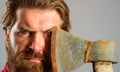 Bearded man with axe. Canadian lumberjack with hatchet. Logger tool. Male with ax. Closeup portrait. Royalty Free Stock Photo