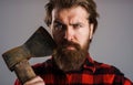 Bearded man with axe. Logger tools. Canadian lumberjack with hatchet. Male with ax. Closeup portrait. Royalty Free Stock Photo