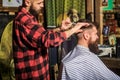 Bearded man in barber shop. Work in the barber shop. Man hairstylist. Hairdresser cutting hair of male client. Man Royalty Free Stock Photo