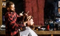 Bearded man in barbershop. Work in the barber shop. Hairdresser cutting hair of male client. Hairstylist serving client Royalty Free Stock Photo