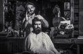 Bearded man in barbershop. Work in the barber shop. Hairdresser cutting hair of male client. Hairstylist serving client Royalty Free Stock Photo