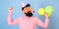 Bearded man in birthday cap and huge crazy glasses dancing, party hard, fun time concept. Hipster with trimmed beard and