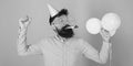 Bearded man in birthday cap and huge crazy glasses dancing, party hard, fun time concept. Hipster with trimmed beard and