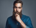 Bearded man in blue denim with serious expression