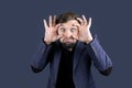 The bearded man in the blue suit bulged his huge eyes Royalty Free Stock Photo