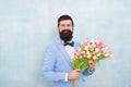 Bearded man in bow tie with tulip flowers. bride groom at wedding party. spring bouquet. 8 of march. love date with Royalty Free Stock Photo