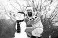 bearded man build snowman. happy hipster ready to celebrate xmas. winter season activity. man santa hat play with snow