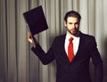 Bearded man, businessman with laptop in suit and red tie