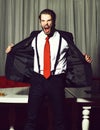 Bearded angry man, businessman in suit and red tie