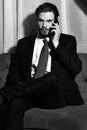 Bearded man, businessman speaking on cell phone with red tie