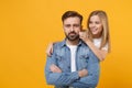 Bearded man in casual clothes have fun with cute child baby girl. Father little kid daughter isolated on yellow wall Royalty Free Stock Photo