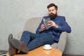 Bearded man ceo read book relaxing in armchair during rest break, reading