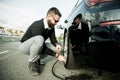 Bearded man checking tire pressure Royalty Free Stock Photo