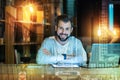 Smart man smiling while sitting at the table after his working day Royalty Free Stock Photo