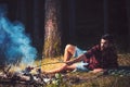 Bearded man cook food on bonfire. Hipster with beard roast sausage on fire. Man in plaid shirt relax on nature. Tourist