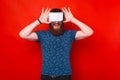 Bearded man is covering his eyes with screen of a tablet. Royalty Free Stock Photo