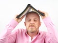 Bearded man covers his head with an open Bible Royalty Free Stock Photo