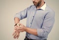 Bearded man cropped view look at wrist watch dial, time check