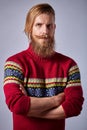 Bearded man with curled mustache knit red sweater standing