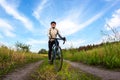 bearded man cyclist rides a bike on a road in nature. sports, hobbies and entertainment for health Royalty Free Stock Photo