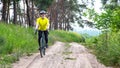 bearded man cyclist in yellow clothes rides a bike on a road in nature. sports, hobbies and entertainment for health Royalty Free Stock Photo