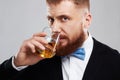 Bearded man enjoying a brandy or whiskey