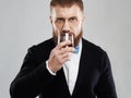 Bearded man enjoying a brandy or whiskey