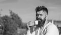 Bearded man with espresso mug, drinks coffee. Coffee break concept. Man with long beard looks strict and serious. Man Royalty Free Stock Photo