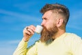 Bearded man with espresso mug, drinks coffee. Man with long beard enjoy coffee. Coffee gourmet concept. Man with beard