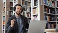 Man listening to music in library and starting dancing Royalty Free Stock Photo