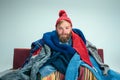 Bearded Man with Flue Sitting on Sofa at Home. Healthcare Concepts.