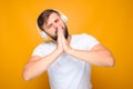 Man folded his palms in front of his face and listens to emotional music