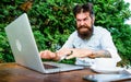 Bearded man freelance worker. Remote job. Freelance professional occupation. Hipster busy with freelance. Wifi and Royalty Free Stock Photo