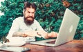 Bearded man freelance worker. Remote job. Freelance professional occupation. Hipster busy with freelance. Wifi and Royalty Free Stock Photo