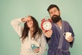Bearded man and girl coffee cup. wake up time. family life routine. couple alarm clock. love relations. Drowsy and weak