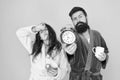 Bearded man and girl coffee cup. wake up time. family life routine. couple alarm clock. love relations. Drowsy and weak
