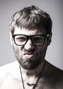 Bearded man in glasses plays the fool. crazy man, funny expression Royalty Free Stock Photo