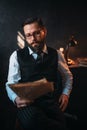 Bearded man in glasses reads handwritten text Royalty Free Stock Photo