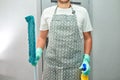 Bearded man in gloves with cleaning stuff, mop, disinfectant spray bottle in hand Royalty Free Stock Photo