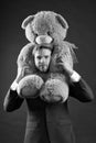 Bearded man with grey teddy bear. Businessman hold big animal toy. Fashion manager with toy gift or present. Birthday or