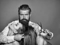 Bearded man hairdresser and two women Royalty Free Stock Photo