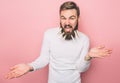 Bearded man has a a few closepins in his beard. He is screaming. Isolated on pink background. Royalty Free Stock Photo