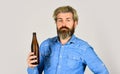 Bearded man has hangover. mature man drink beer. healthy water in glass bottle. brutal hipster drinking alcohol beverage