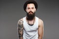 Bearded Man in Hat. hipster boy with tattoo Royalty Free Stock Photo