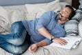 Bearded man with headphones sleeping on couch Royalty Free Stock Photo