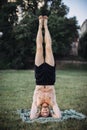 Yoga at park. Bearded man doing yoga in the green park. Concept of a healthy lifestyle