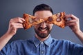 Bearded man hiding eyes with pizza slices