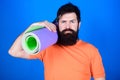 Bearded man hipster with fitness mat. Sporty man training in gym. Sport mat equipment. Athletic regime. Health and diet
