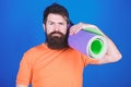 Bearded man hipster with fitness mat. Sporty man training in gym. Sport mat equipment. Athletic regime. Health and diet