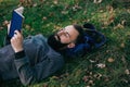 Bearded man hipster reading a book and relax in park Royalty Free Stock Photo